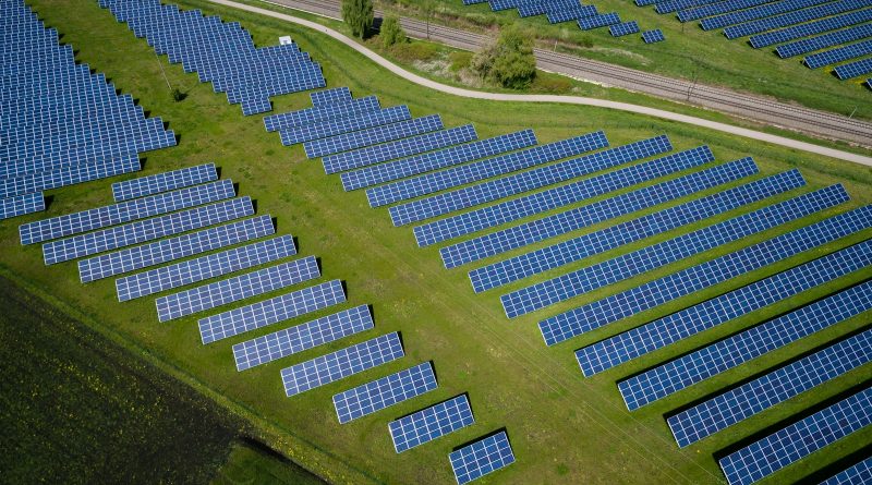 aerial photography of grass field with blue solar panels